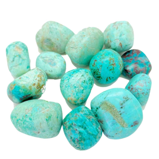 Multiple tumbled Peruvian turquoise stones on a white background, showing their natural teal and aqua colors with distinctive matrix markings