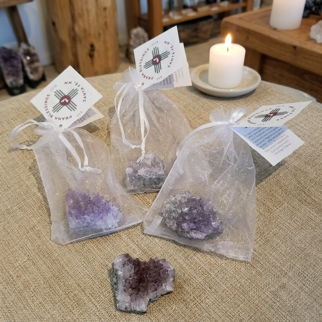 Small Amethyst clusters with included gift bags in a warm setting