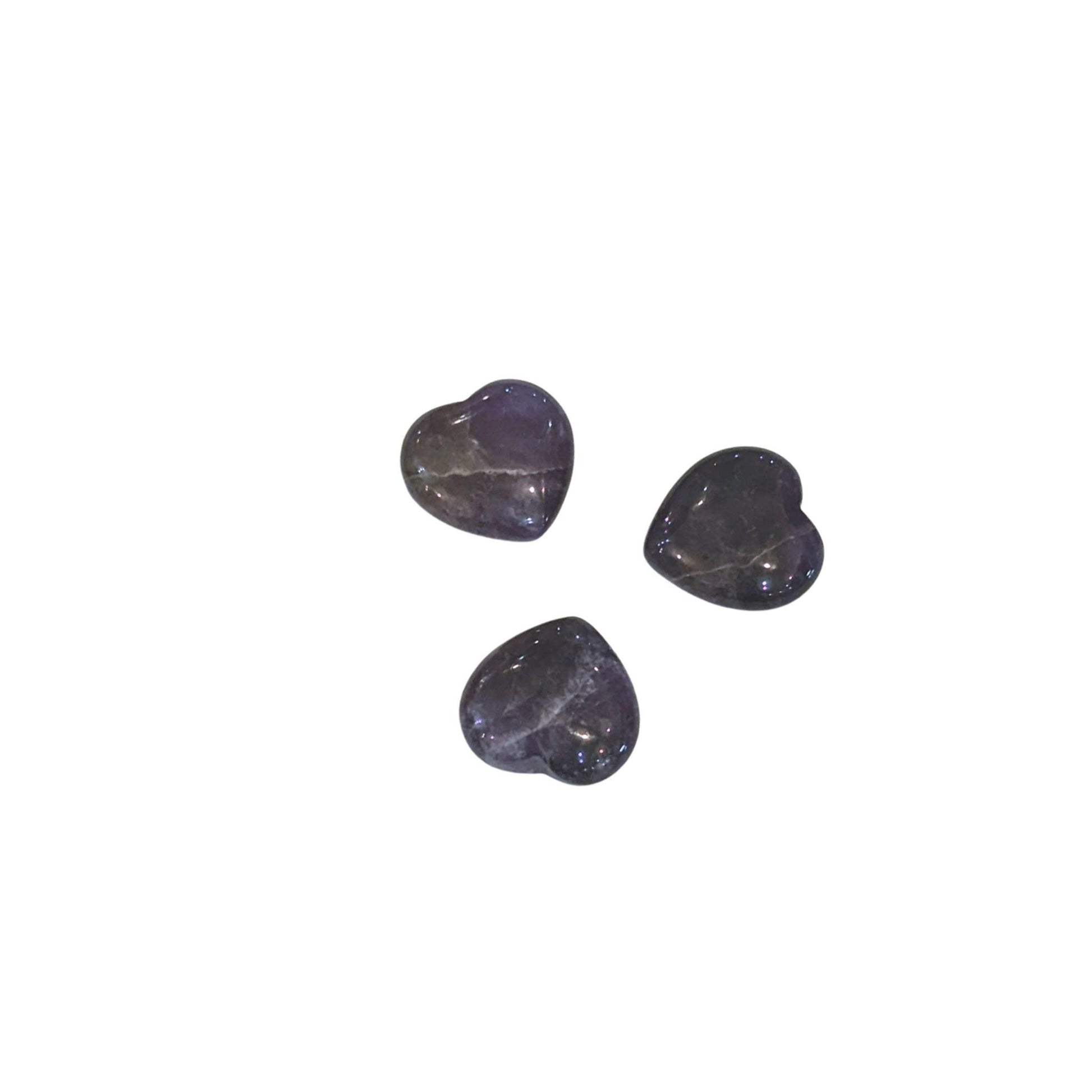 Three small heart-shaped polished dark purple amethyst stones arranged on a plain white background.