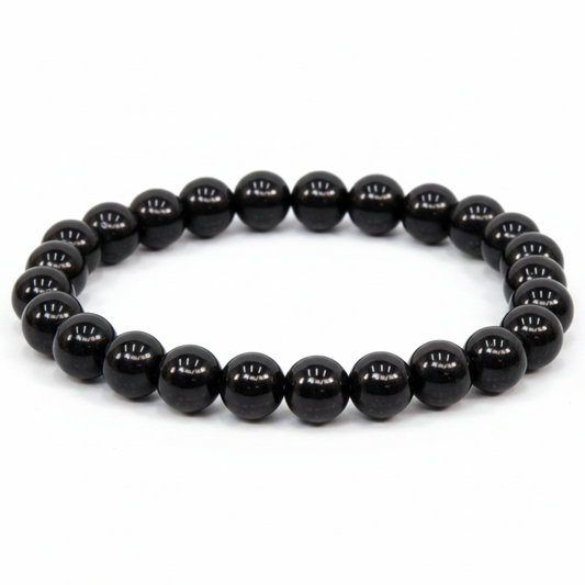 Black Obsidian 8mm beaded bracelet on white background — glossy jet black volcanic glass crystal bracelet by Prana Blessings