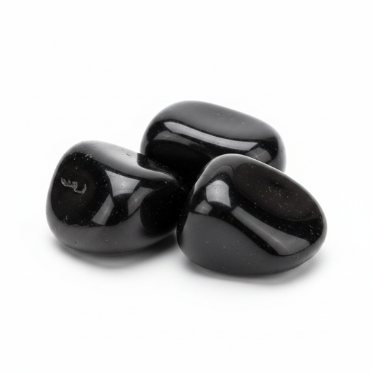 Polished black obsidian tumbled stones arranged on a clean white background.