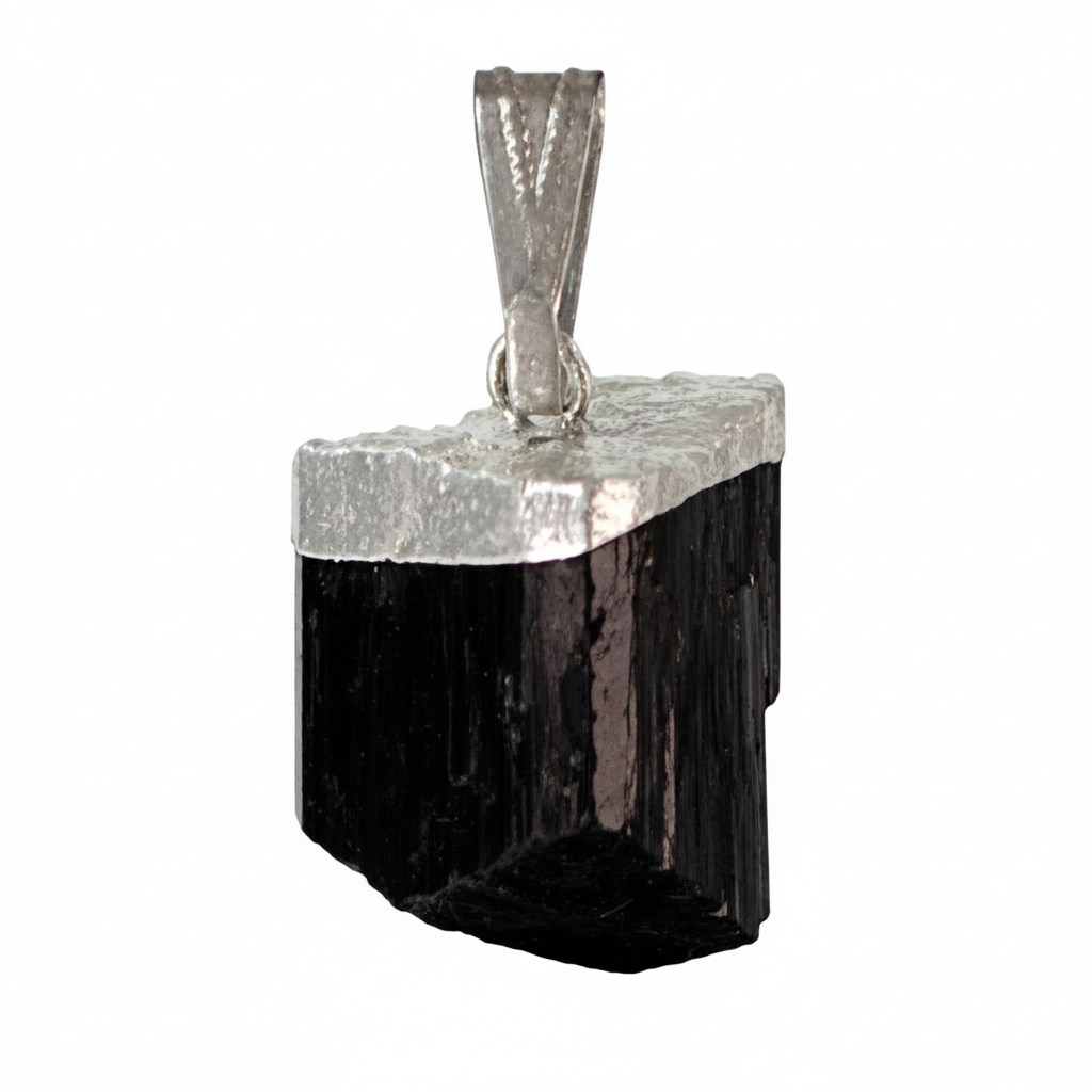Rough Black Tourmaline crystal pendant with silver-tone cap and chain on a white background