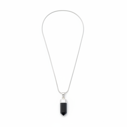 Polished Black Tourmaline pendant with silver-tone bail on a white background