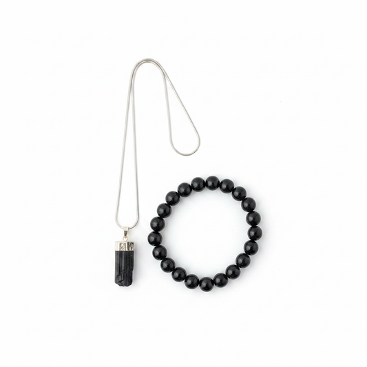 Black Tourmaline pendant and beaded bracelet set on a white background