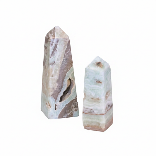 Polished Caribbean Calcite obelisk with blue and cream banding on a white background