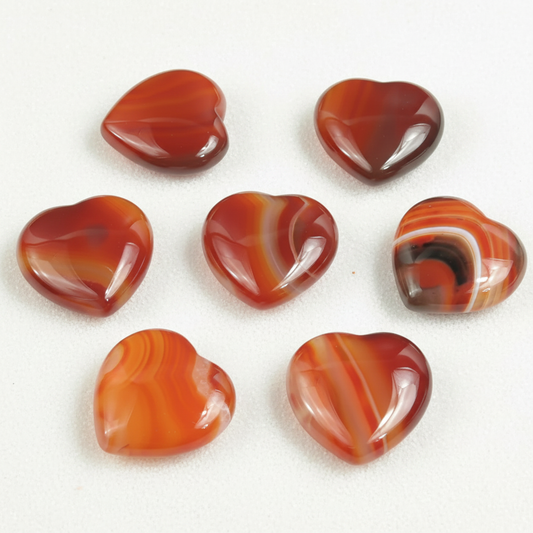 Carnelian Small Heart shown clearly on a clean white background, highlighting its color, shape, and natural variation.