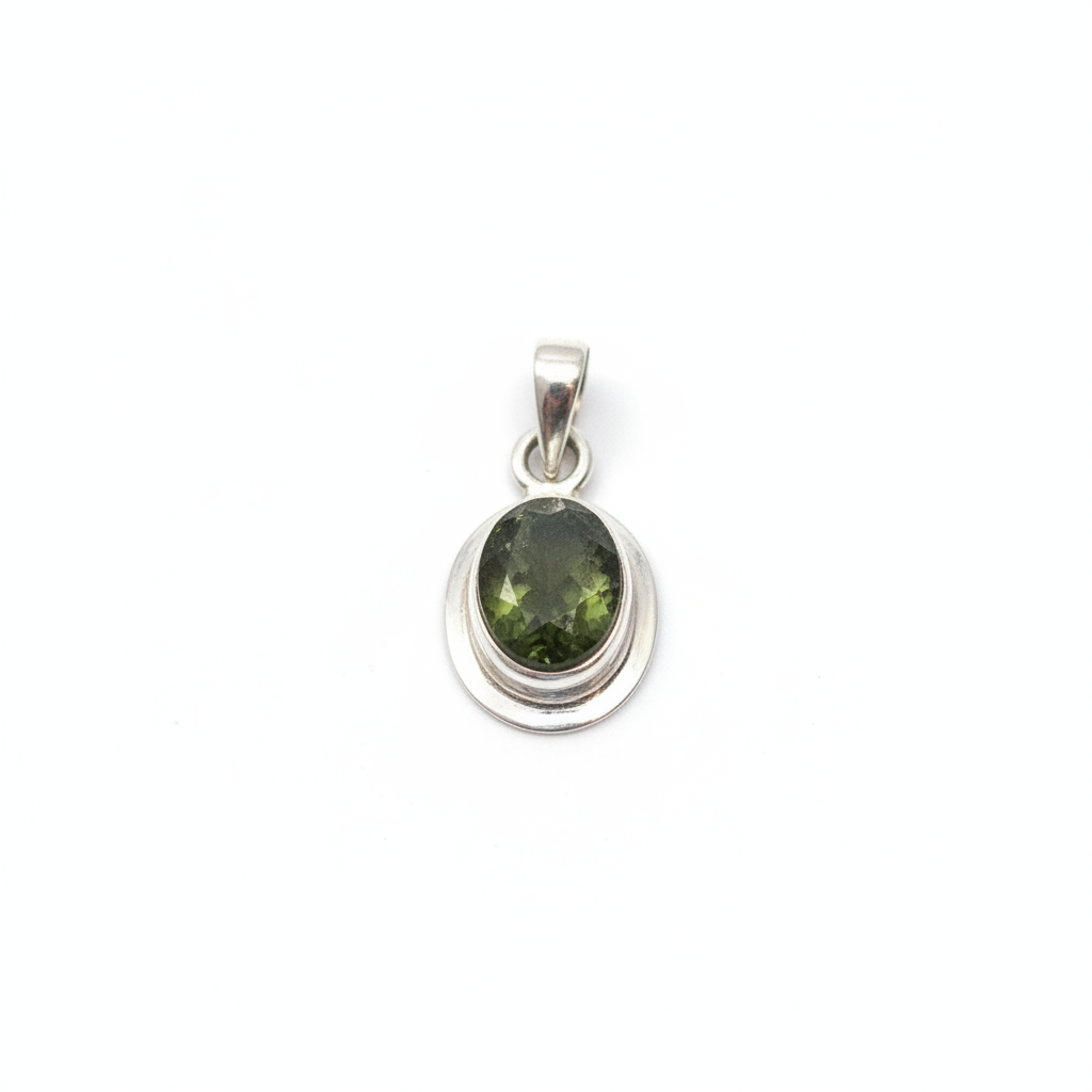 Faceted green Moldavite pendant in sterling silver on a white background