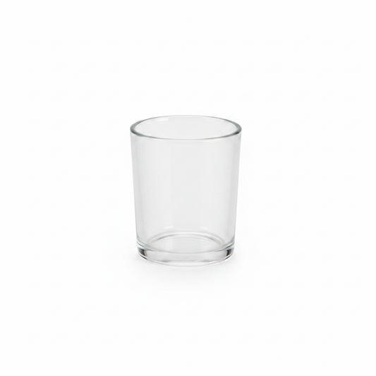 Clear glass votive candle holder on a white background