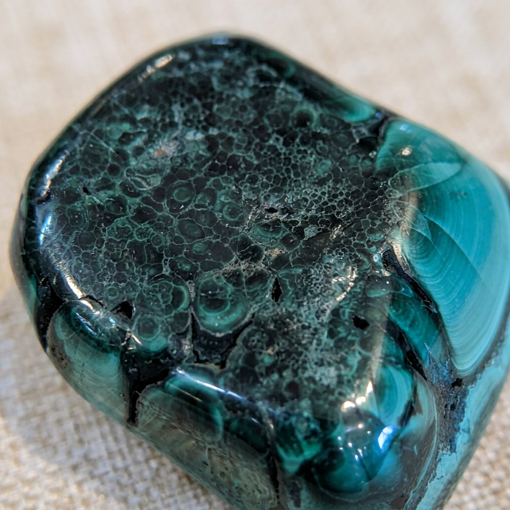 Close view of natural green banding on the small Malachite freeform