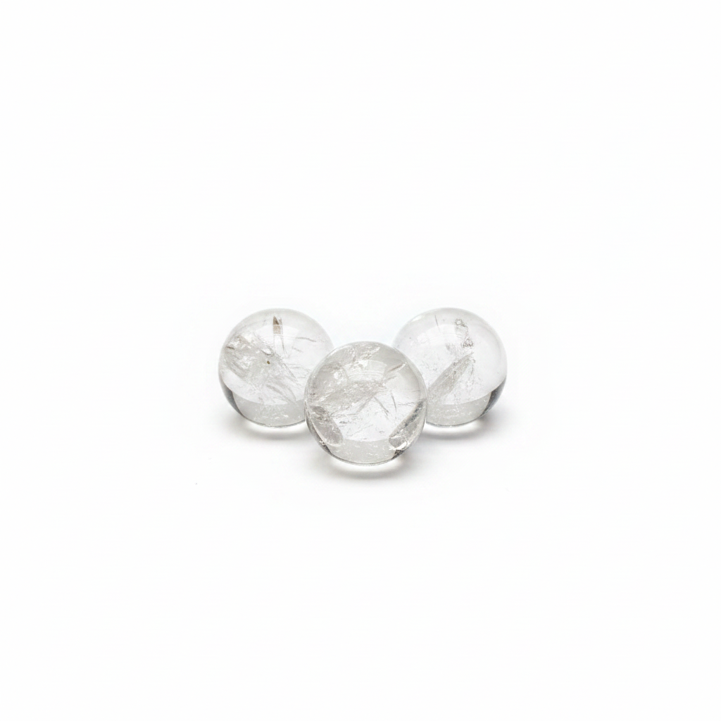 Mini polished Clear Quartz spheres on a clean light background
