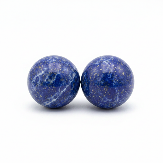 Mini polished deep blue Lapis Lazuli spheres on a clean light background