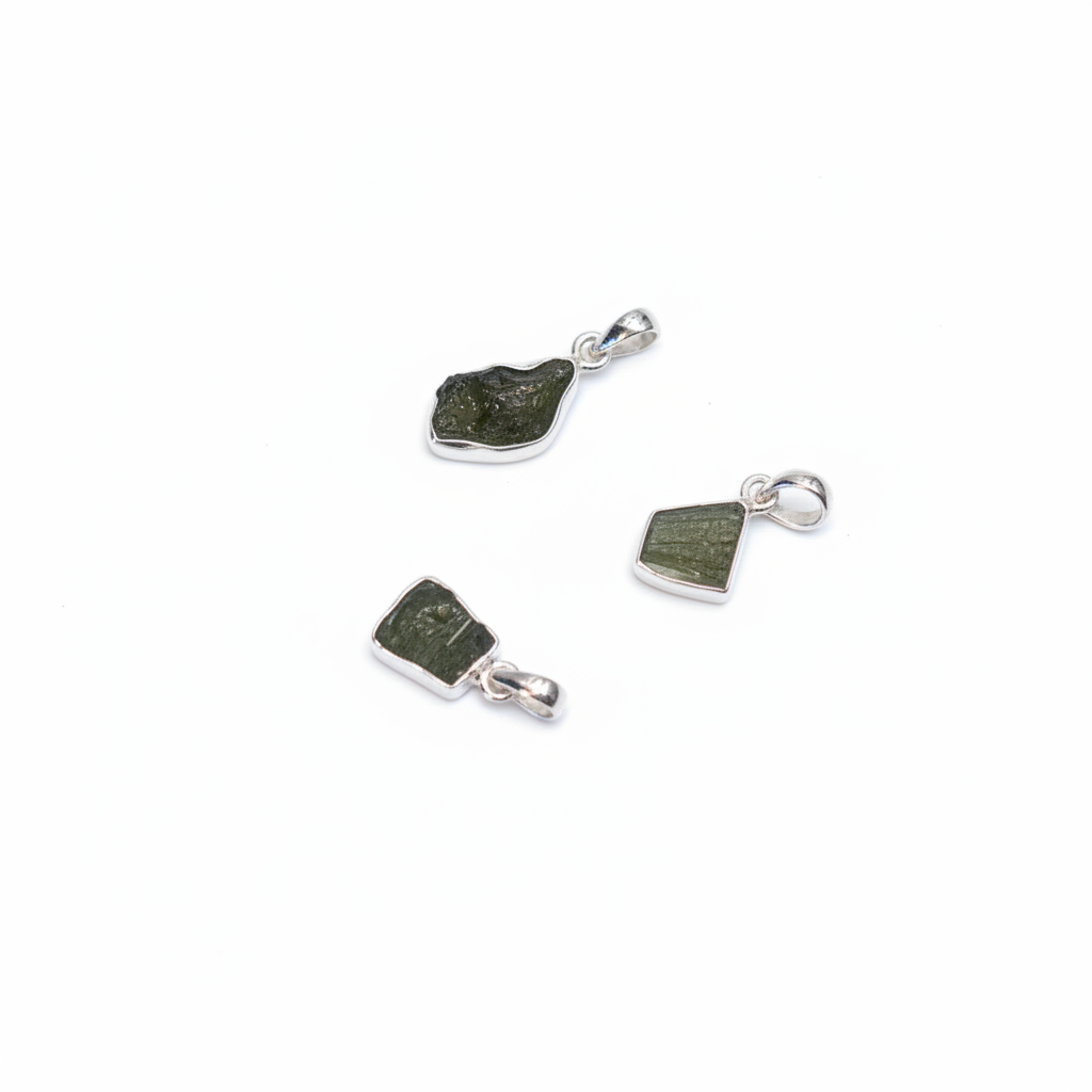 Natural green Moldavite pendant in sterling silver on a white background