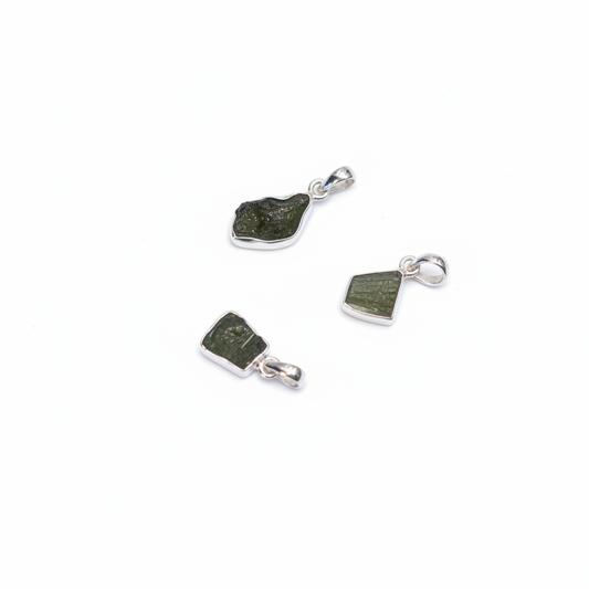 Natural green Moldavite pendant in sterling silver on a white background