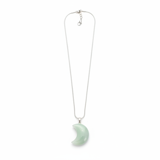 Soft green New Jade crescent moon pendant with chain on a white background