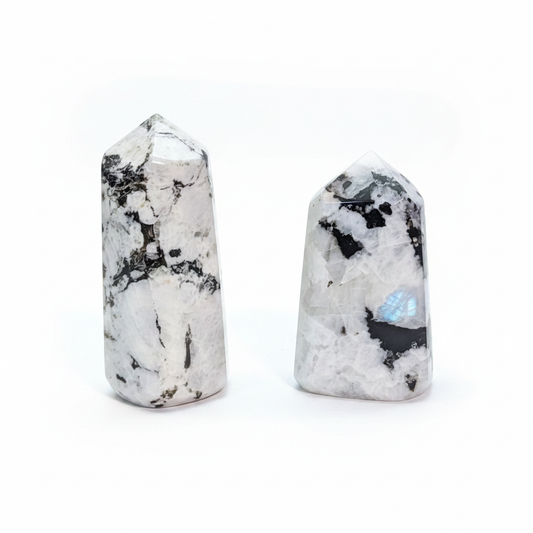 Polished Rainbow Moonstone freeform tower with natural dark inclusions on a white background