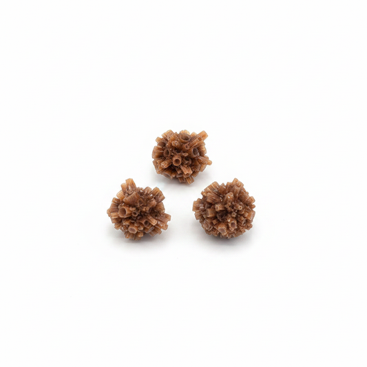 Small natural Red Aragonite star clusters on a clean light background