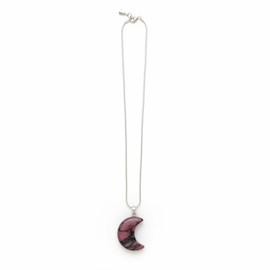 Pink and black Rhodonite crescent moon pendant with chain on a white background
