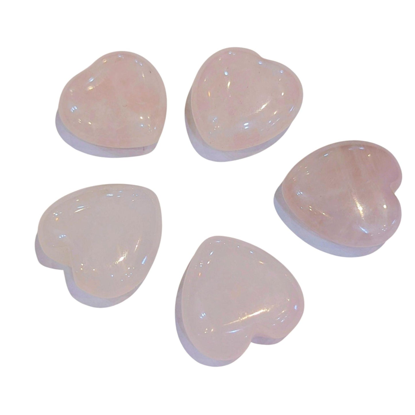 Five smooth, polished heart-shaped rose quartz beads arranged in a circle on a white background.
