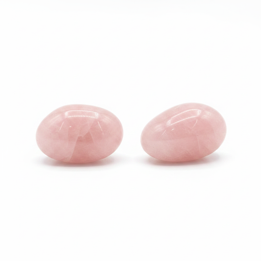 Polished Rose Quartz pebble palm stone on a white background