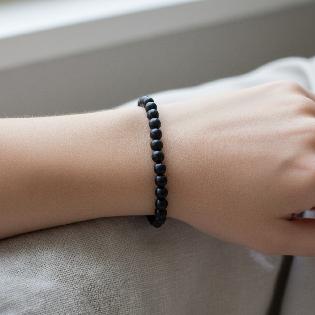 Lifestyle view of a Shungite 8mm bead bracelet worn on the wrist